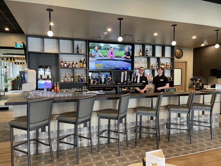 Bartenders at the lounge bar at Smitty's Niverville with sports on TV
